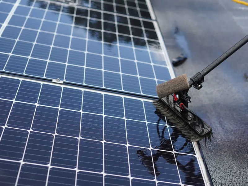 Brush cleaning dust and debris from residential rooftop solar panels